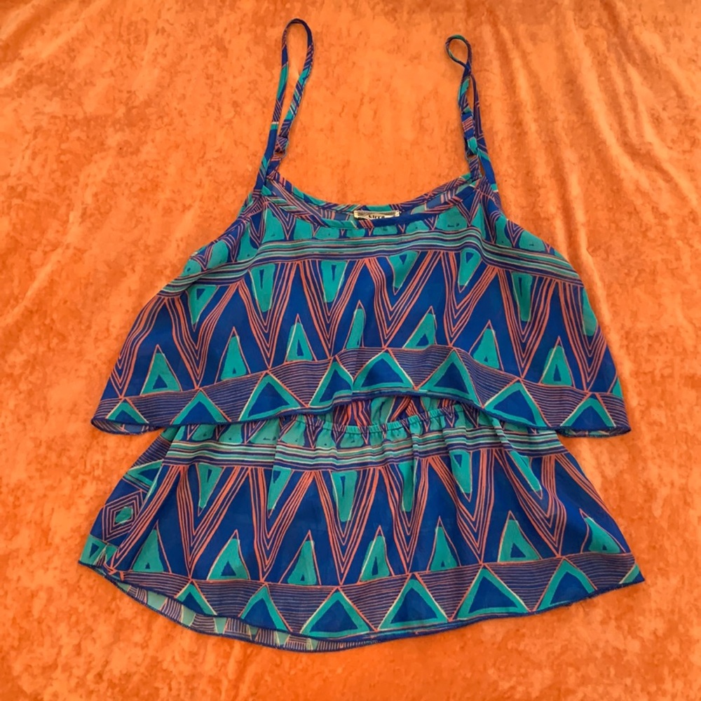 Blue patterned tank with open back.